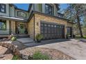 Charming two-story home featuring a stone facade and a three-car garage at 1410 Old Sequoia Ct, Franktown, CO 80116