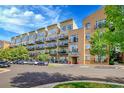Modern apartment building featuring multiple balconies and street parking at 7240 W Custer Ave # 301, Lakewood, CO 80226