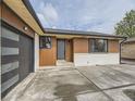 Close up of the entrance of the property, highlighting the front door, garage door, and wooden accents at 920 S Hudson St, Denver, CO 80246