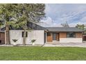 Charming single-story home features a well-manicured front yard with mature trees and new landscaping at 920 S Hudson St, Denver, CO 80246