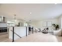 Open-concept living space with lots of natural light, hardwood floors, modern railings and neutral decor at 920 S Hudson St, Denver, CO 80246
