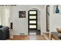 Inviting foyer with hardwood floors, contemporary lighting, and an arched doorway at 720 S Clayton St, Denver, CO 80209