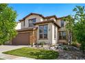 Charming two-story home with stone accents, a two-car garage, and a well-manicured front yard at 15275 W La Salle Ave, Lakewood, CO 80228