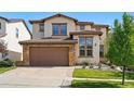 Inviting two-story home boasts manicured lawn, stone accents, and a two-car garage at 15275 W La Salle Ave, Lakewood, CO 80228