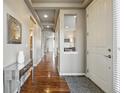 Hallway with hardwood floors, neutral walls, recessed lighting, and an entry door with hardware at 15275 W La Salle Ave, Lakewood, CO 80228