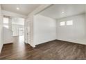 Bright entryway with hardwood floors and views into the living room and staircase at 16485 Alpine Sorrel Dr, Monument, CO 80132