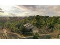 A home nestled within a lush, tree-filled community, beautiful landscaping, and scenic mountain views at 7649 Pineridge Ter, Castle Pines, CO 80108