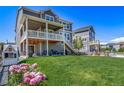 Expansive backyard features a spacious deck, lush lawn, and a charming playhouse at 23879 E Narrowleaf Pl, Aurora, CO 80016