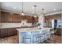 Spacious kitchen with granite countertops, stainless steel appliances, and a large center island at 23879 E Narrowleaf Pl, Aurora, CO 80016