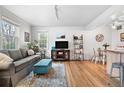 Bright living room with hardwood floors, sofa, ottoman, and decor at 6330 E 13Th Ave, Denver, CO 80220