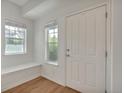 Light-filled entryway with hardwood floors, white trim, and a convenient built-in bench under the windows at 3186 Springmeadow Cir, Castle Rock, CO 80109