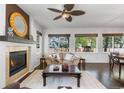 Cozy living room featuring a fireplace, large windows, and a comfortable sofa at 2231 E 128Th Ave, Thornton, CO 80241