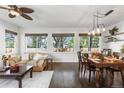 Bright living room with hardwood floors, modern lighting, and multiple windows providing natural light at 2231 E 128Th Ave, Thornton, CO 80241