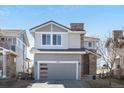 Two-story home featuring a modern garage door, well-kept yard, and inviting curb appeal at 10627 Rutledge St, Parker, CO 80134