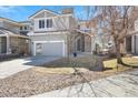 Attractive two-story house with a modern garage door and a well-landscaped front yard at 10627 Rutledge St, Parker, CO 80134