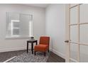 Cozy home office with an accent chair and natural light from the window at 10627 Rutledge St, Parker, CO 80134