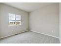 Bright bedroom with a large window and neutral carpet at 18308 Martinello Dr, Parker, CO 80134