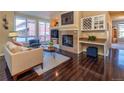 This living room showcases a fireplace, a built-in bar, hardwood floors, and cozy seating at 1735 N Ogden St # 106, Denver, CO 80218