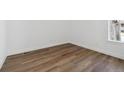 Bright bedroom featuring wood flooring and natural light from the large window at 8616 Pennycress Dr, Littleton, CO 80125