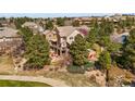 Aerial view of home showcasing its spacious backyard, outdoor patio, and lush green surroundings at 6462 S Versailles Ct, Aurora, CO 80016