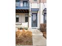 Stylish front door with transom window, decorative pots, and a charming porch swing enhances the home's appeal at 10305 Martin Luther King Blvd, Denver, CO 80238