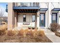 Cozy front porch with decorative swing, stylish planters, and welcoming entrance to the modern townhome at 10305 Martin Luther King Blvd, Denver, CO 80238