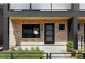 Modern brick home with black framed windows and front door that has decorative glass panels at 425 S Pearl St, Denver, CO 80209