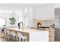 Bright kitchen featuring a large island with seating and stainless steel appliances at 425 S Pearl St, Denver, CO 80209