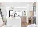 Open kitchen with a large center island, modern appliances, and stylish pendant lighting at 425 S Pearl St, Denver, CO 80209