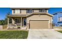 Charming two-story home featuring a covered porch and a two-car garage at 5090 Miriam Ln, Parker, CO 80134