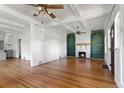 Bright and airy living room featuring hardwood floors, a fireplace, and open layout at 7801 Valley View St, Louviers, CO 80131