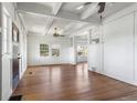 Spacious living room featuring hardwood floors, white walls, large windows, and abundant natural light at 7801 Valley View St, Louviers, CO 80131