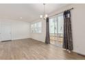Bright dining room area showcasing wood floors, sliding glass doors to the back, and lots of natural light at 21821 E 7Th Ave, Aurora, CO 80018