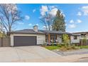 Charming single-story home featuring a landscaped front yard and an attached garage at 2905 Regis Dr, Boulder, CO 80305