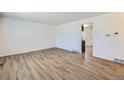 Bright and airy living room with newly installed floors and fresh paint ready for your personal touches at 6010 S Garland Way, Littleton, CO 80123