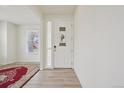 Bright foyer with wood floors and a view of the front door at 12854 Clearview St, Firestone, CO 80504