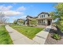 Street view of lovely homes featuring well-manicured lawns and sidewalks at 15957 E Elk Pl, Denver, CO 80239
