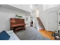 Bright entryway boasts an upright piano, staircase, and an abundance of natural light streaming through multiple windows at 12261 N Holly Way, Brighton, CO 80602