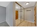 Hallway featuring tiled floors, a mirrored closet, and neutral paint at 2227 Canyon Blvd # 312A, Boulder, CO 80302