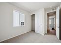 A bedroom featuring gray carpet, a window, and a closet with sliding doors at 1392 Rock Cliff Ave, Erie, CO 80516