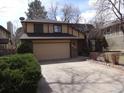 Traditional two-story home with a two-car garage and a spacious driveway, perfect for Gathering living at 11772 E Adriatic Pl, Aurora, CO 80014
