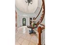 Spacious foyer features tile flooring, curved staircase, and decorative accents for a grand entrance at 1027 S Fillmore Way, Denver, CO 80209