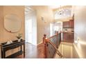 Inviting entryway with hardwood floors, chandelier, and staircase with iron railing at 2317 Winding Dr, Longmont, CO 80504