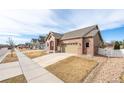 Lovely brick home with an attached two-car garage on a sunny day at 2317 Winding Dr, Longmont, CO 80504