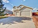 Charming home featuring stone accents, a spacious driveway, and an attached two-car garage at 9711 Millstone Ct, Highlands Ranch, CO 80130