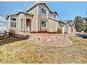 Beautiful two-story home with a stone retaining wall and a well-manicured front yard at 9711 Millstone Ct, Highlands Ranch, CO 80130