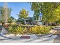 Corner lot home with a green exterior, a front porch, and a privacy fence at 1101 E 7Th Avenue Cir, Broomfield, CO 80020