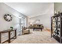 Bright living room with neutral colors, a vaulted ceiling, and large windows at 1101 E 7Th Avenue Cir, Broomfield, CO 80020