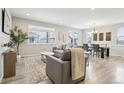 Comfortable living room area with a large window providing natural light to the seating and dining at 617 Iris St, Brighton, CO 80601