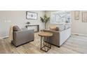 Inviting seating area with modern decor and wood-look floors create a cozy atmosphere at 617 Iris St, Brighton, CO 80601